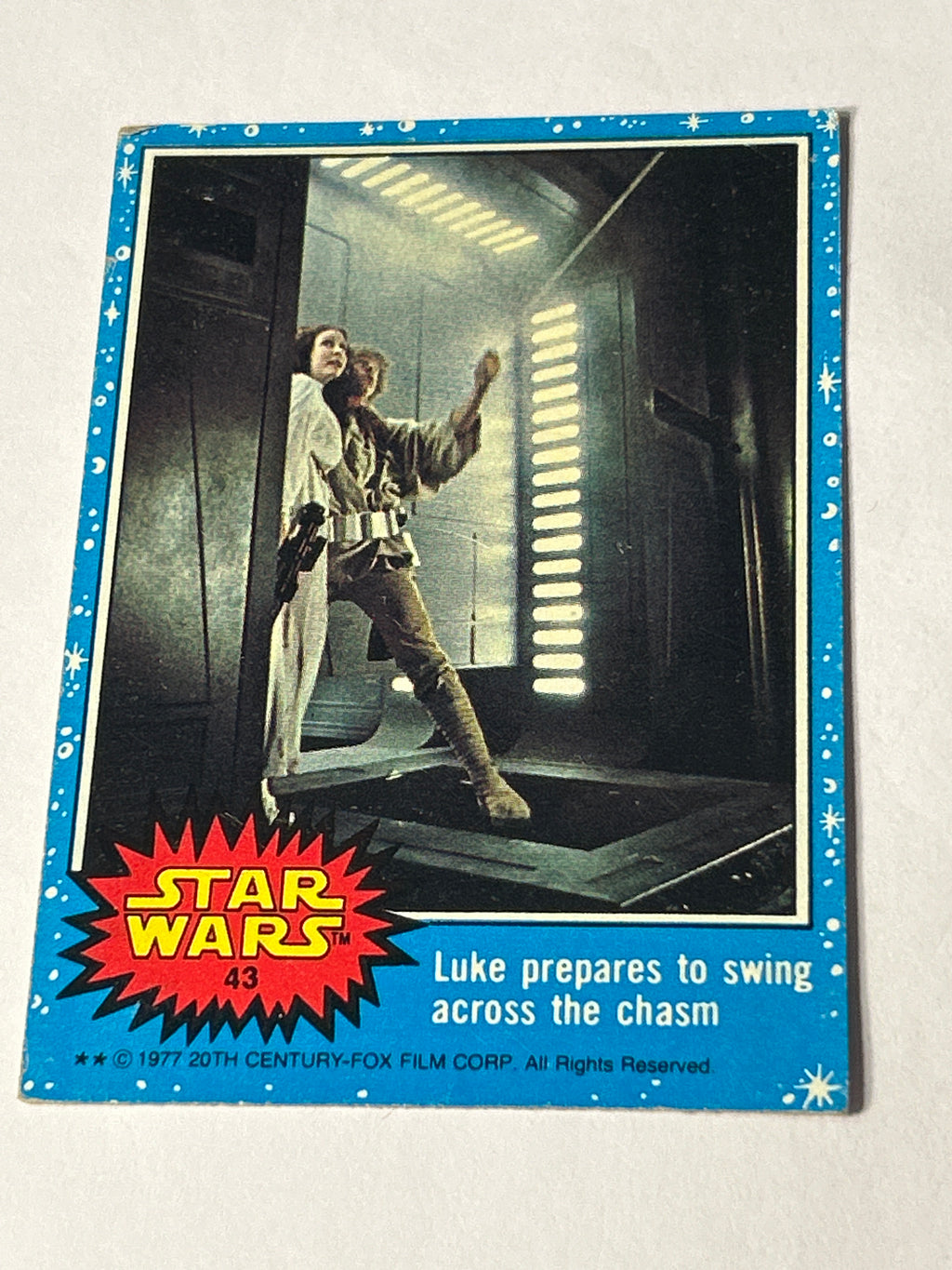 1977 Topps Star Wars #43 Luke Prepares to Swing Across the Chasm, Blue Series 1, Two-Star Variant, VG