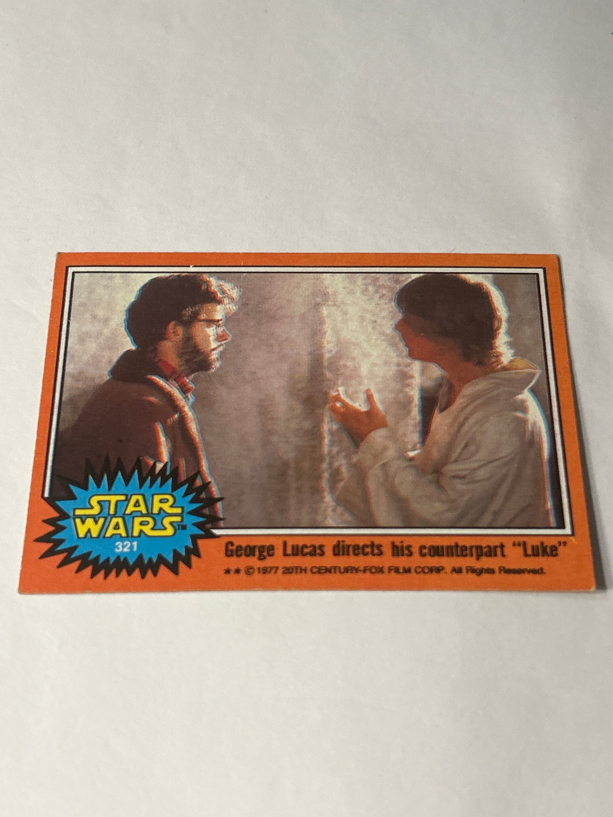 1977 Topps Star Wars Series 5 Orange #321 George Lucas Directs His Counterpart "Luke"