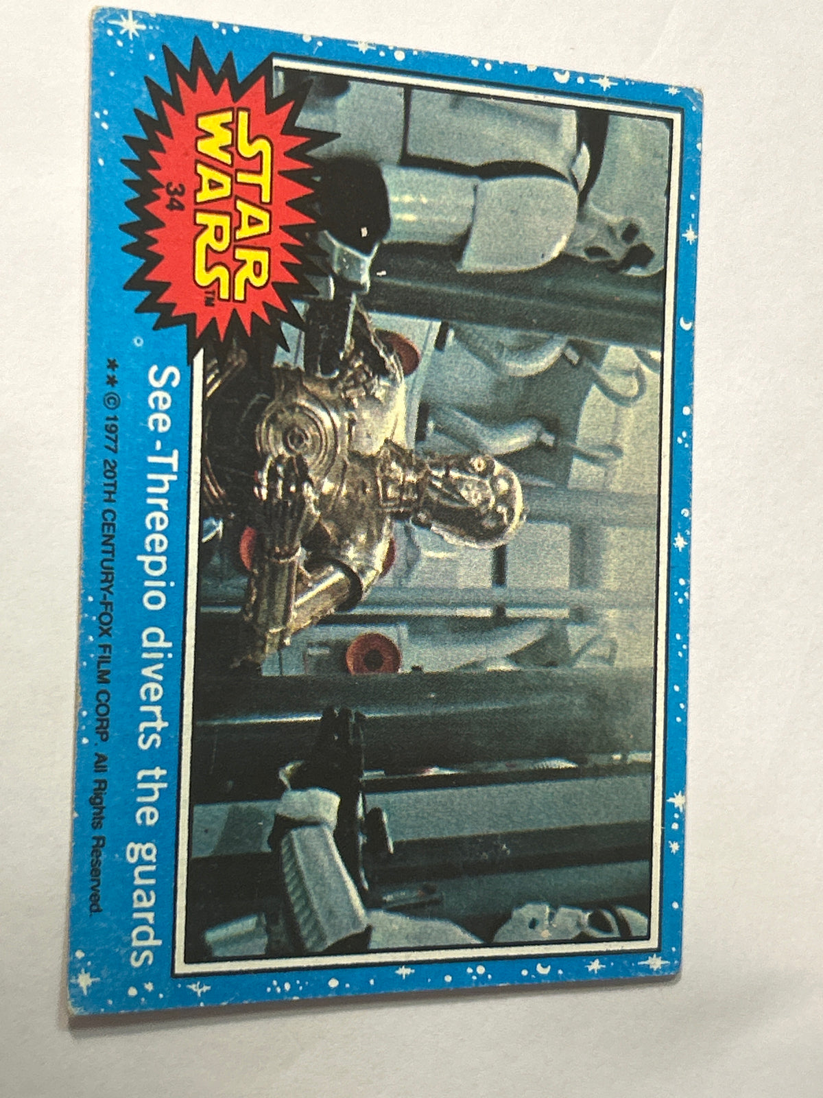 1977 Topps Star Wars Series 1 Blue #34 See-Threepio Diverts the Guards (Puzzle Back)