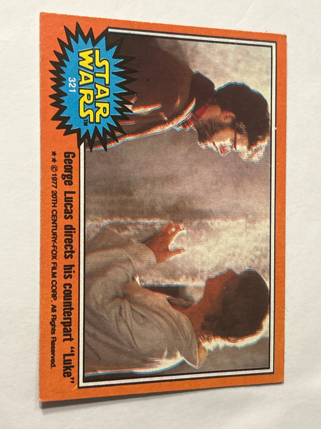 1977 Topps Star Wars Series 5 Orange #321 George Lucas Directs His Counterpart "Luke"